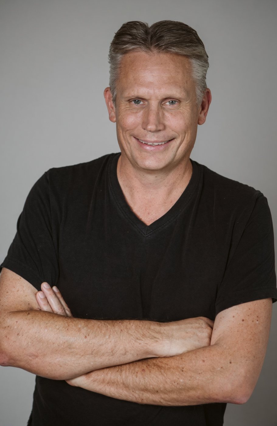 Paul Childers in a black t-shirt, arms crossed