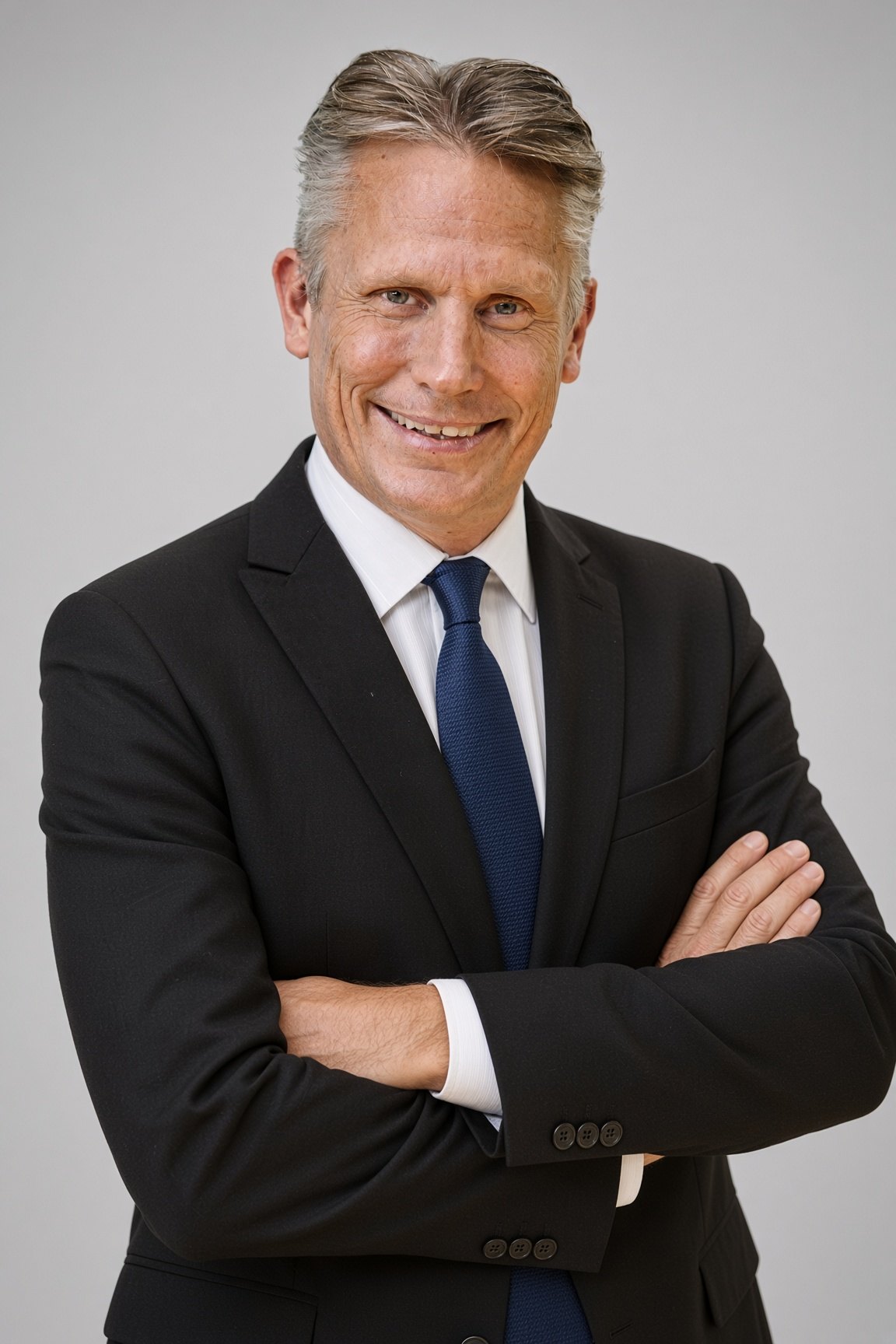 Paul Childers in a suit and blue tie